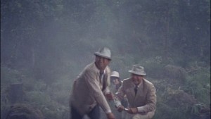 Three people in white suits standing in a cloud of smoke. Filmmaking!
