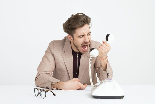 Man yelling into a phone.